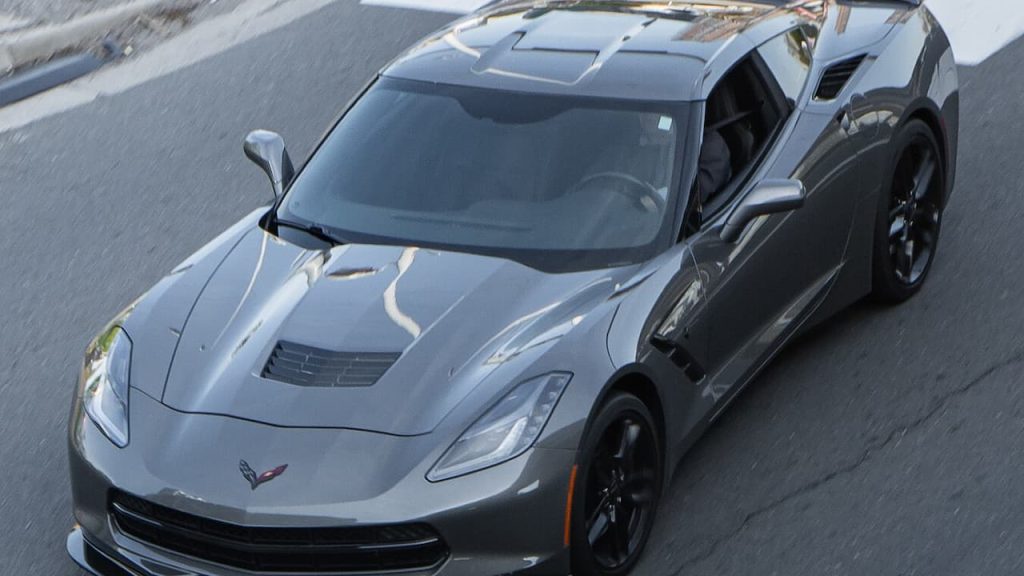 2025 Chevrolet Corvette Stingray sports car with open doors photographed from above on asphalt road
