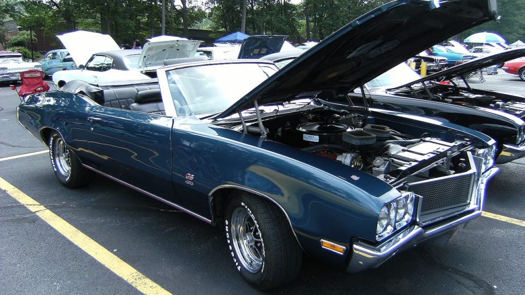 1989 Buick GS 455 convertible with hood open displaying engine at classic car show event