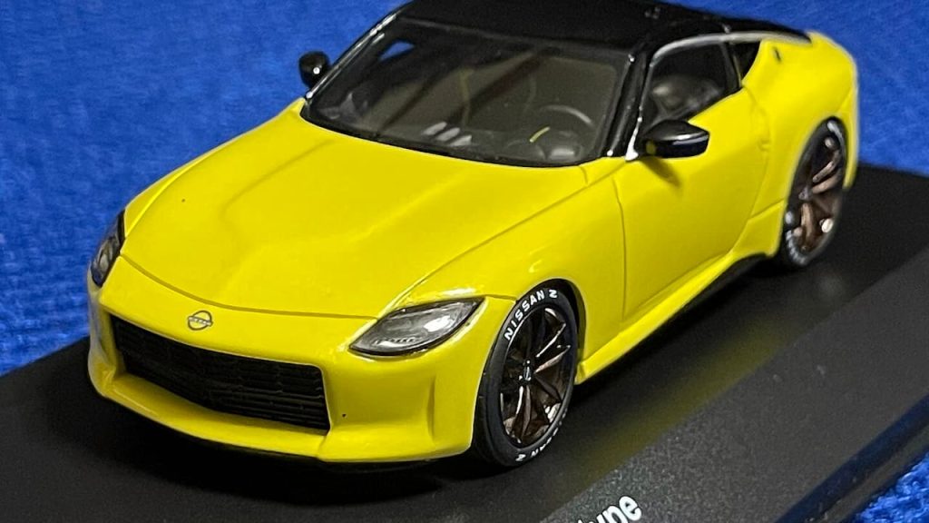  Yellow 2024 Nissan Z Proto model car displayed in blue presentation case with black interior details.