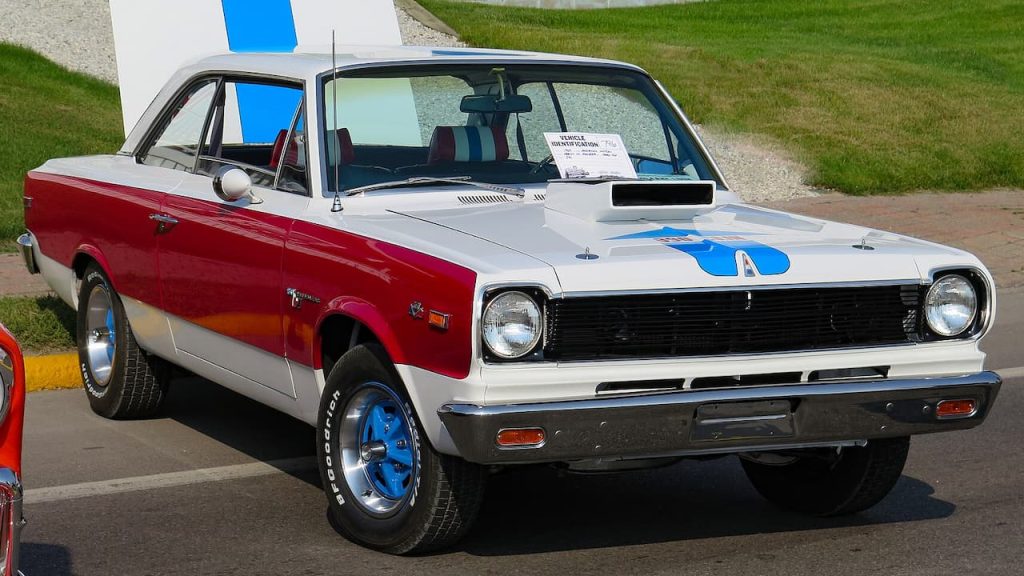 AMC Hurst SC Rambler Scrambler in red, white, and blue, displayed outdoors with hood scoop and racing stripes