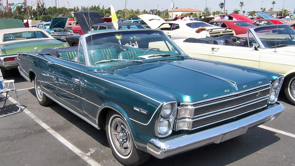 7-liter Ford Galaxie parked at classic car show with numerous vintage vehicles in sunny parking lot