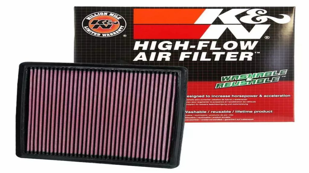 K&N high-flow air filter with red cotton pleated media in black frame displayed beside its retail packaging box
