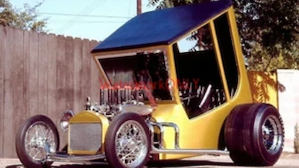 Yellow Uncertain-T Legendary Show Rod featuring exposed engine and oversized rear tires